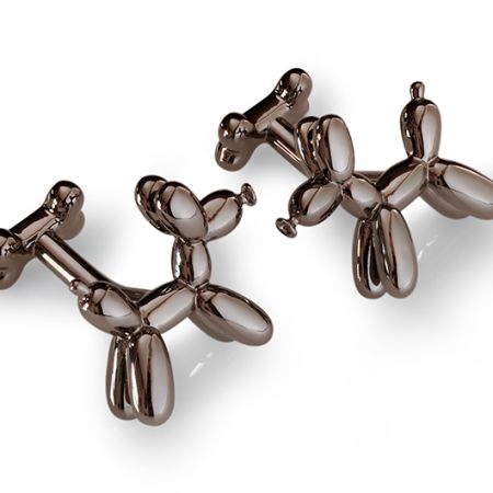 A pair of cufflinks in the shape of a balloon animal dog. The back is in the shape of a bone. They colour is black rhodium or gunmetal.