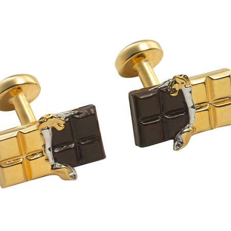 A pair of cufflinks in the style of a chocolate bae, with gold wrapper and brown enamel for the cufflinks