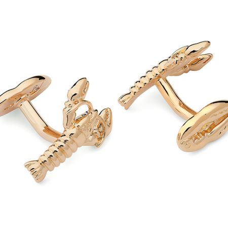 A pair of metal cufflinks in the shape of lobsters. The colour is Yellow Gold